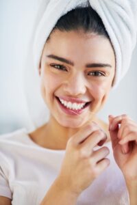 young woman showing off her perfect smile, benefits of cosmetic dentistry