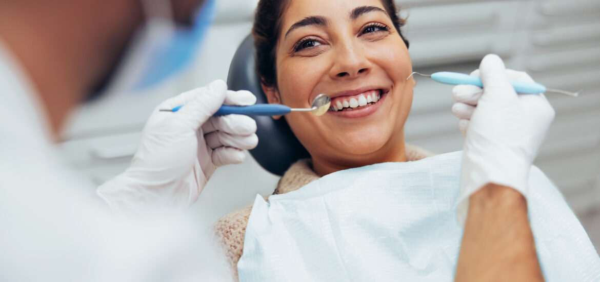 dentist checking a patients mouth for signs of gum issues