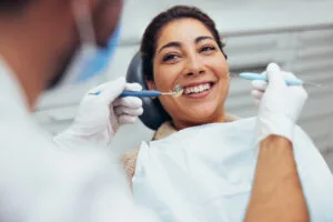 dentist checking a patients mouth for signs of gum issues