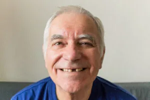 older man smiling, exposing the gaps in his smile