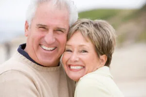 A mature couple smiling after restorative dentistry in White Plains.